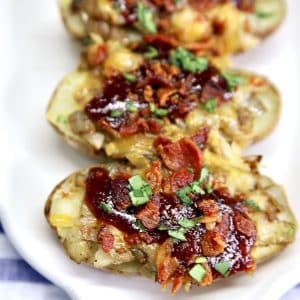 Baked potato halves with cheese, bbq sauce, onions and bacon.
