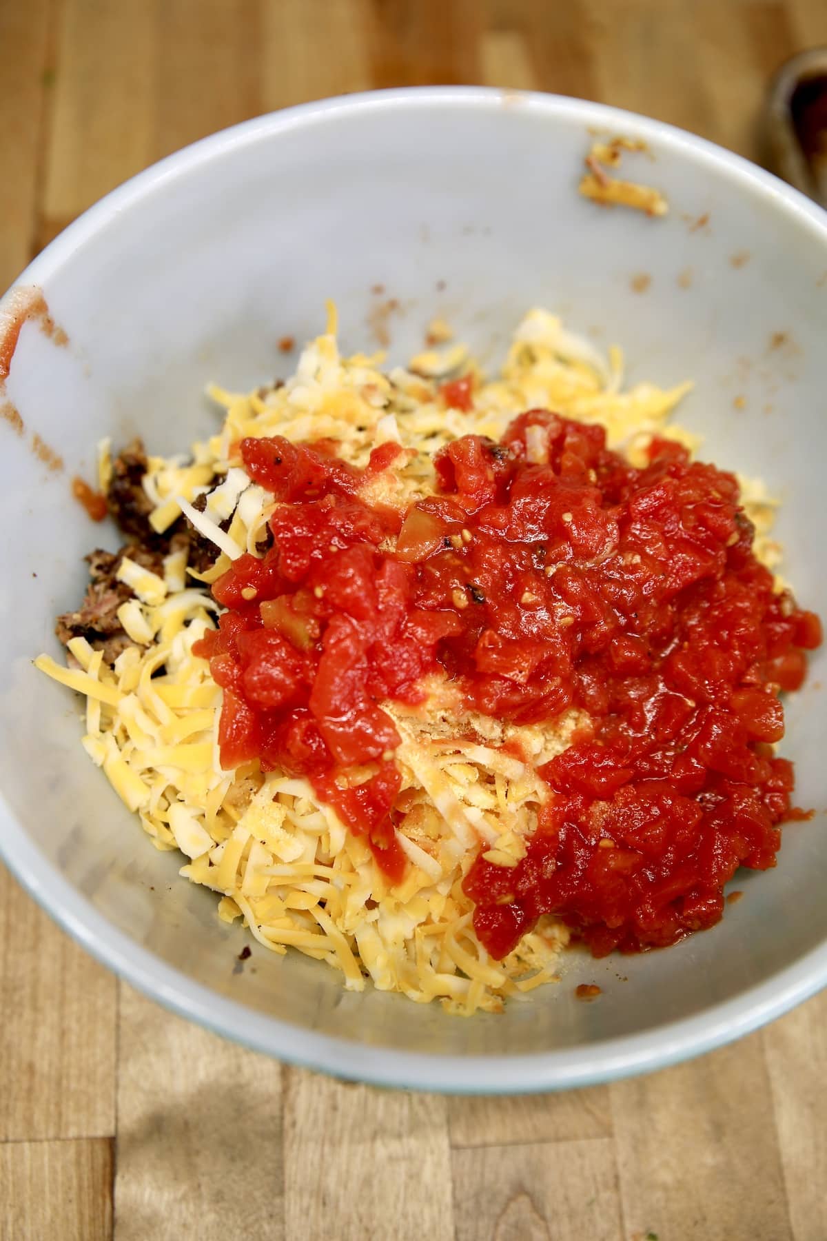 Bowl with tomatoes, cheese, brisket.