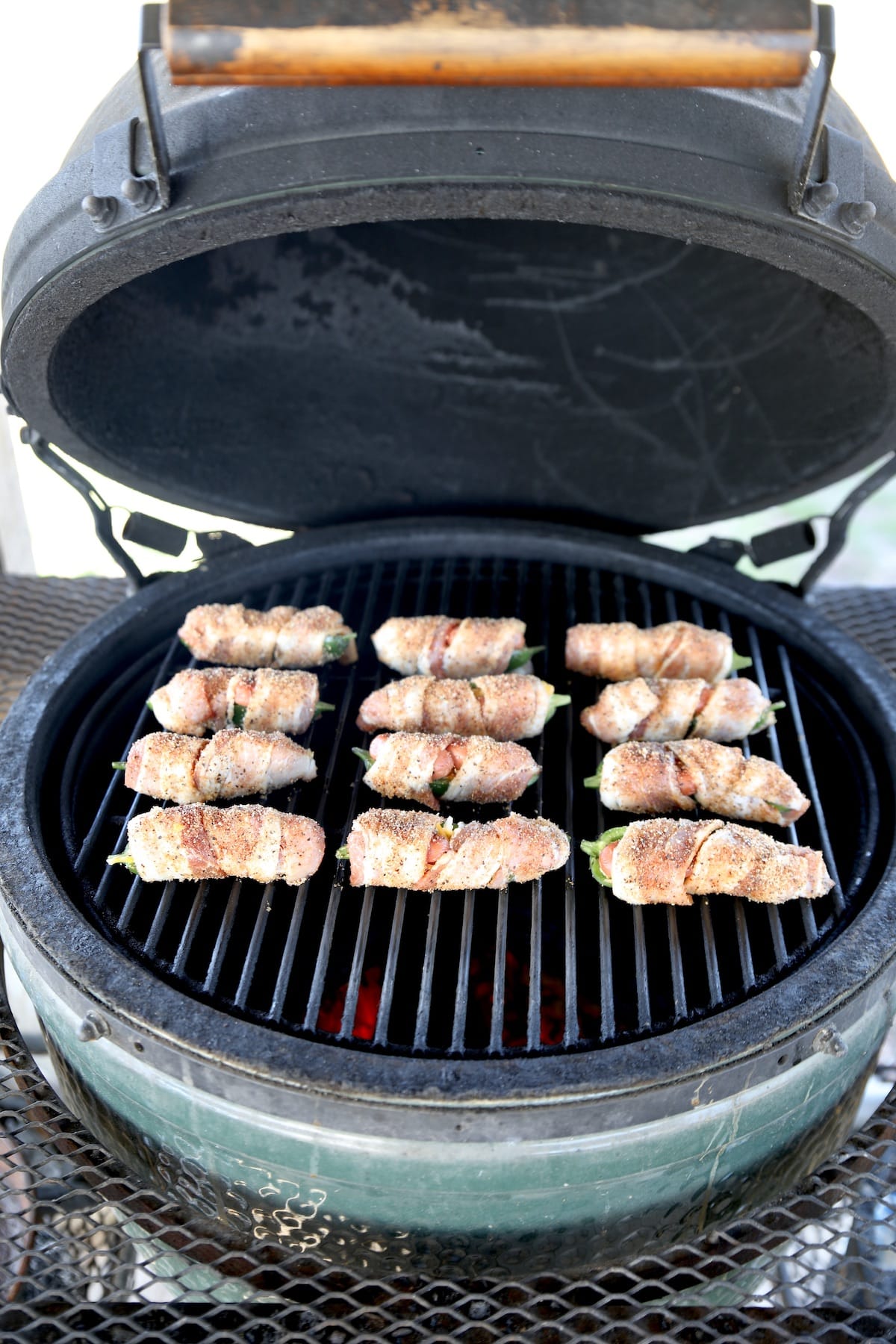 Grilling bacon wrapped poppers.