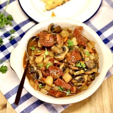 Bowl of beef mushroom stew with spoon.