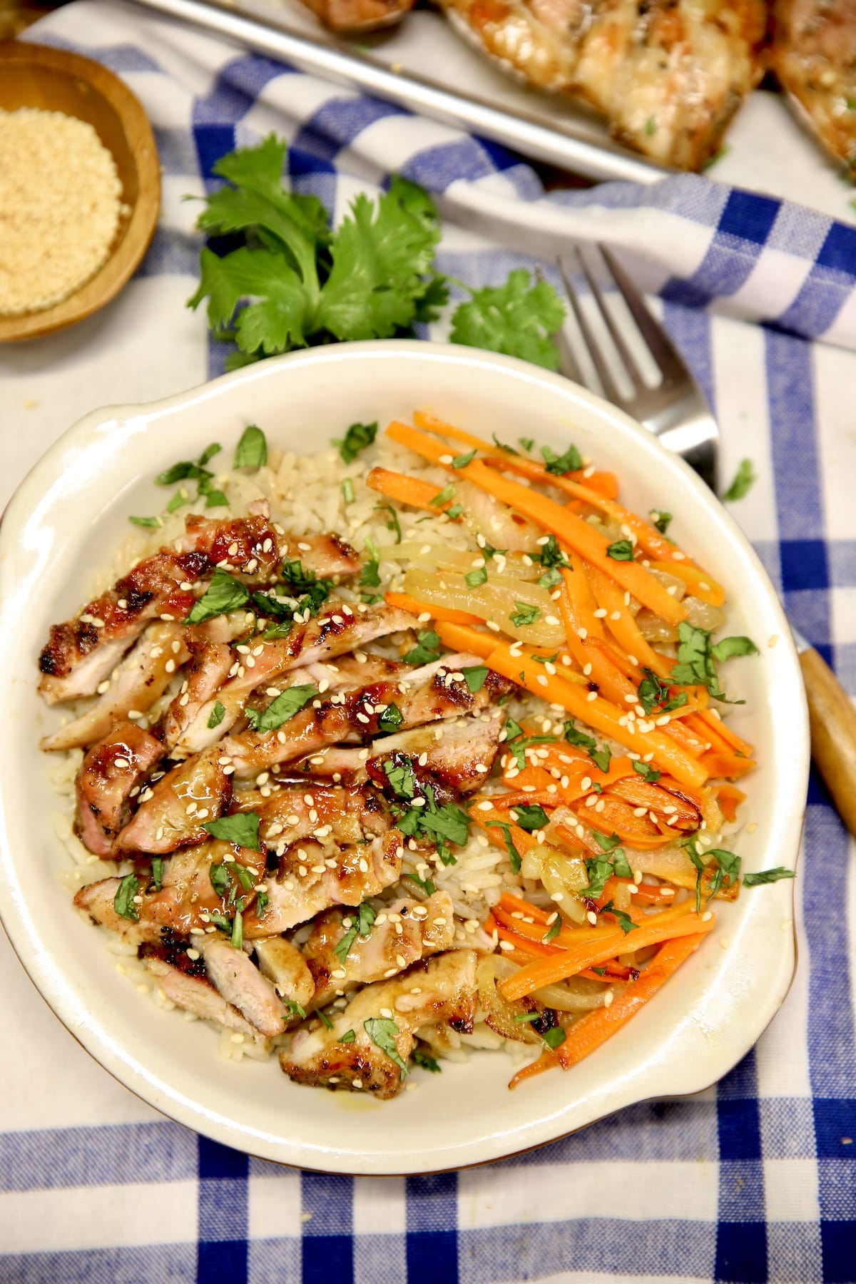 Grilled chicken bowl with julienned carrots.