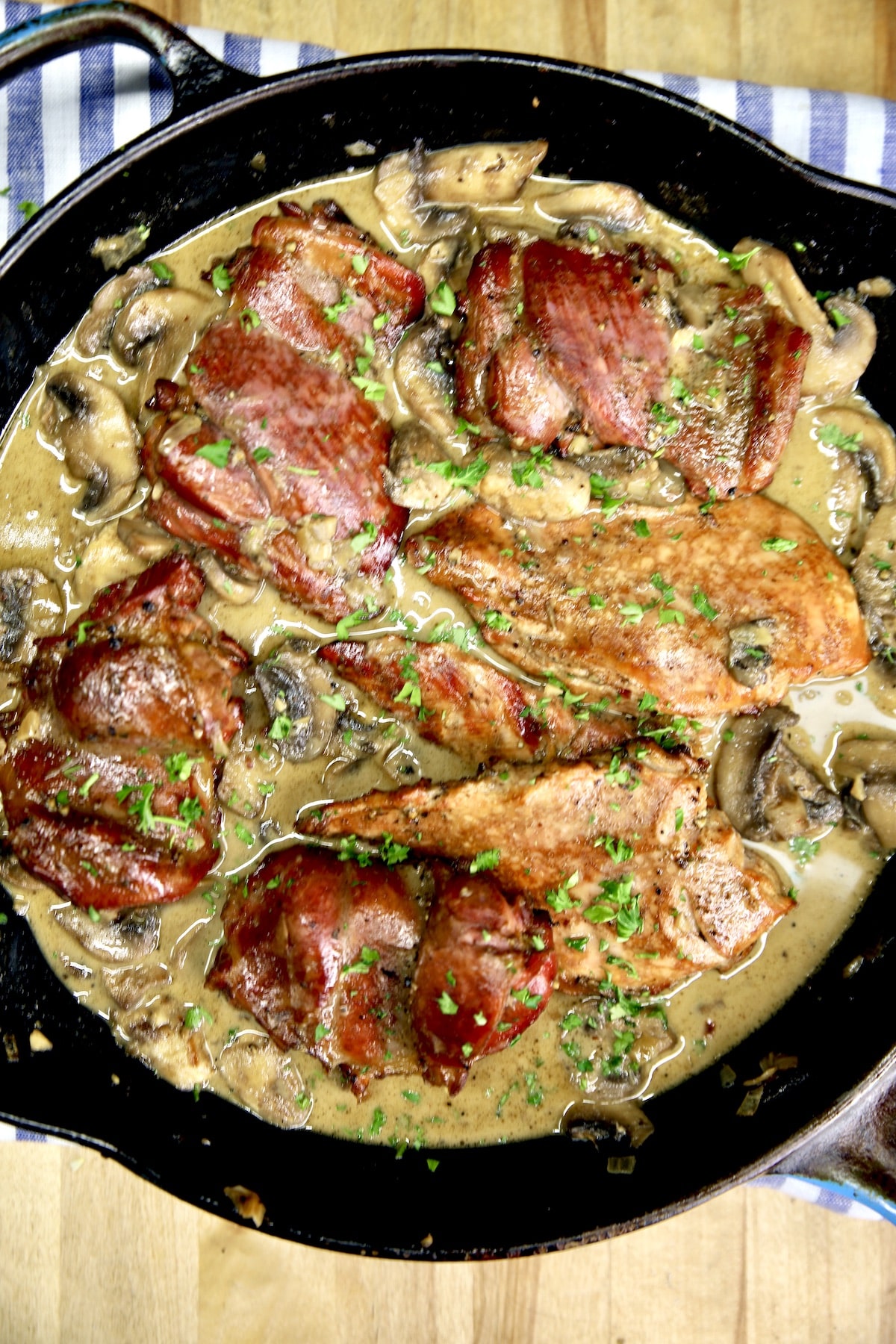 Skillet of chicken with creamy mushrooms sauce.