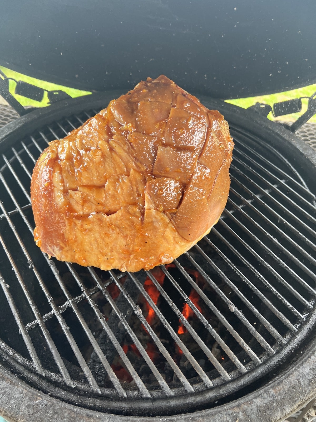 Half ham with glaze on a grill.