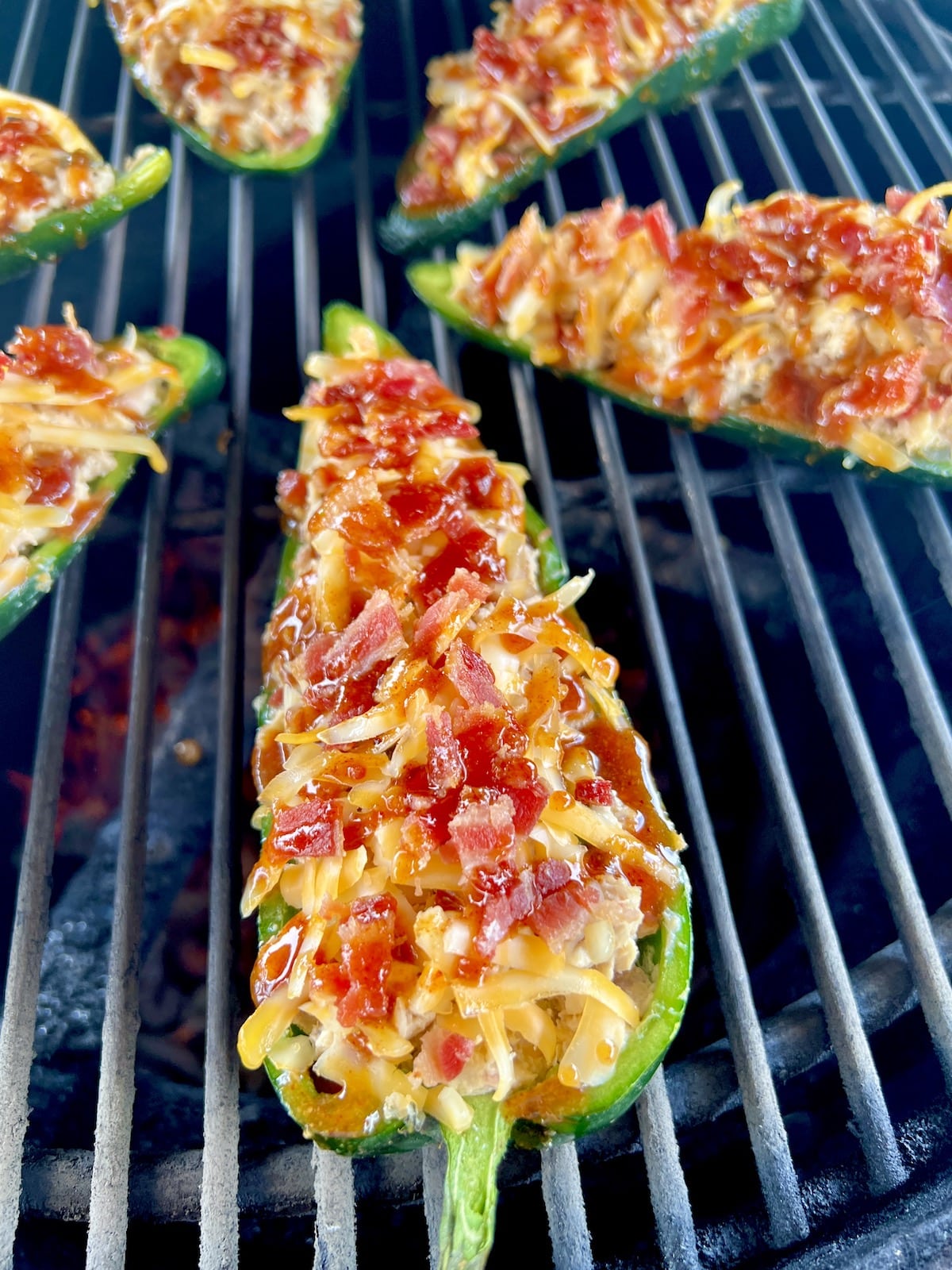 Grilling chicken stuffed peppers.
