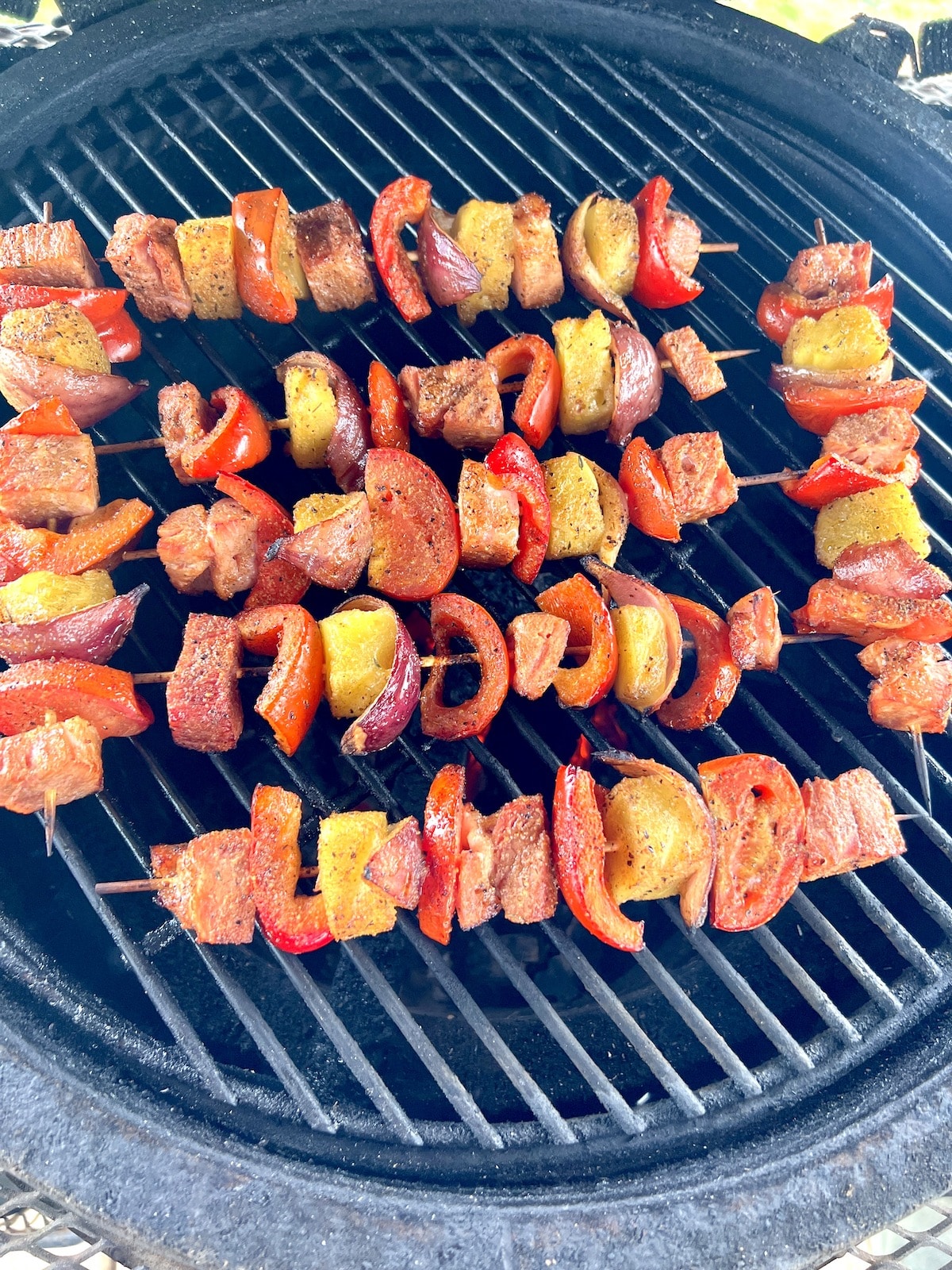 Grilling kabobs with ham, pineapple and vegetables.