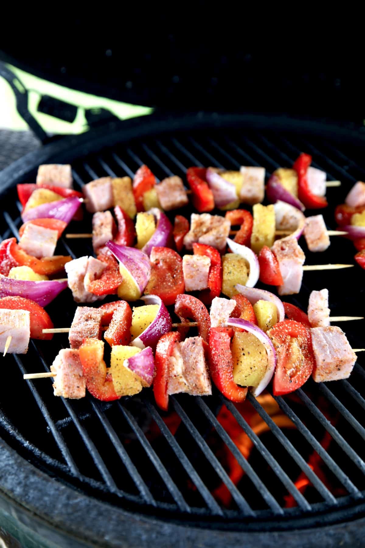 Grilling kabobs with ham, pineapple, vegetables.