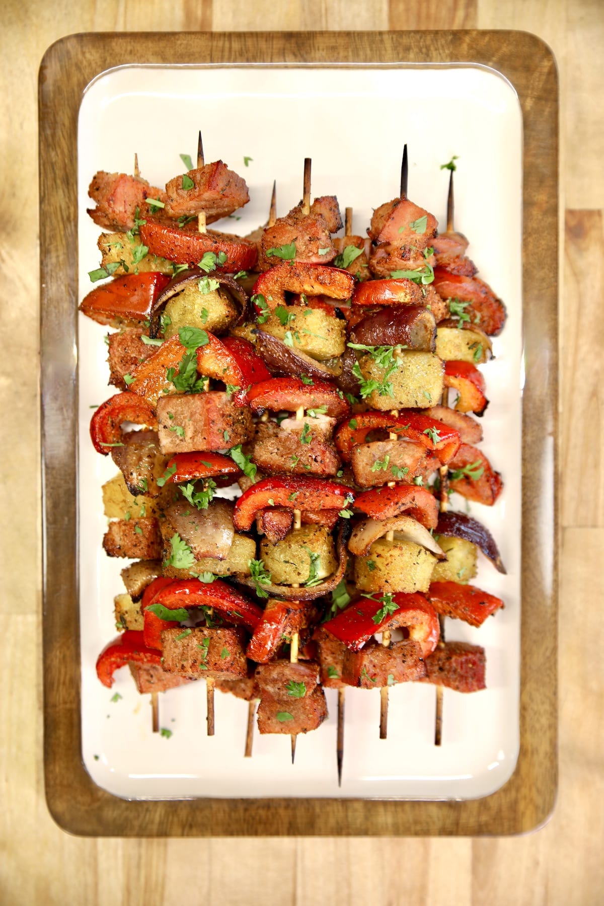 Platter of ham, pineapple and vegetable kabobs.