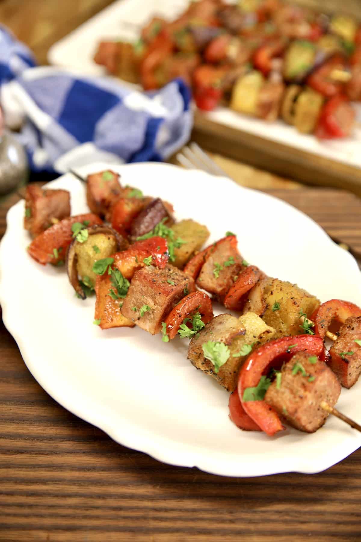 2 kabobs on a plate.