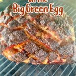 Smoking pork butt on big green egg grill. Text overlay.