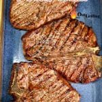 Grilled t-bone steaks on a blue platter, text overlay.