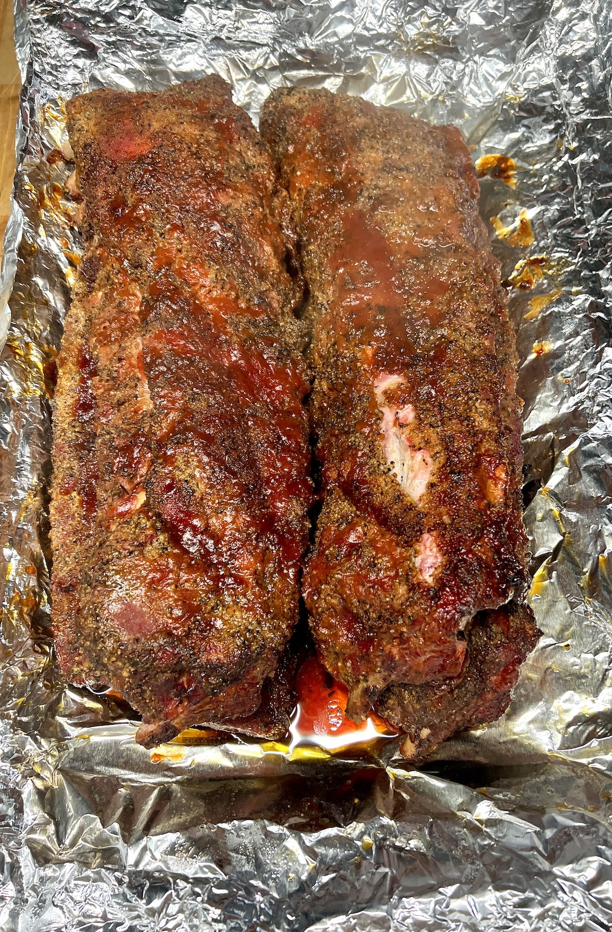 Smoked BBQ baby back ribs on foil.