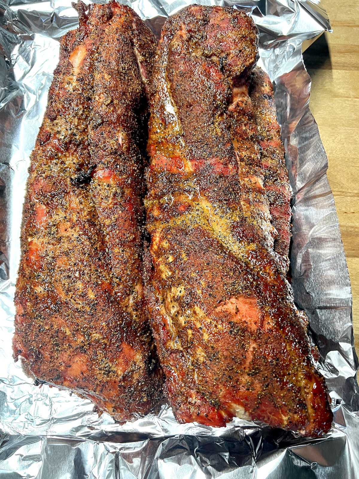 Smoky baby back ribs on foil.