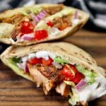 Grilled Chicken Shawarma pita sandwiches with tomatoes and letttuce.
