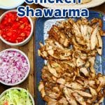 Grilled chicken shawarma platter with toppings and pita bread.
