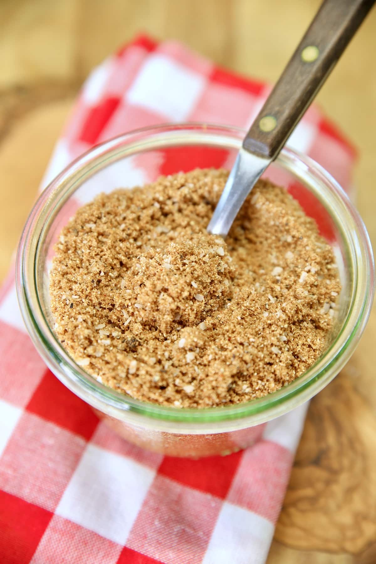 Sweet and smoky rub in a jar with a spoon.