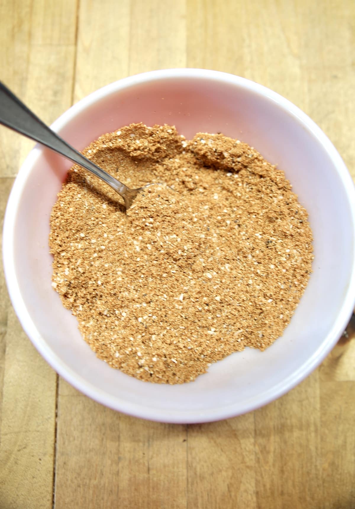 Bowl of dry rub with a spoon.
