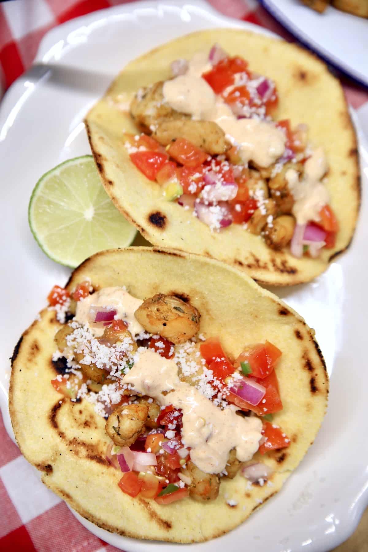 Grilled seafood tacos with taco sauce.