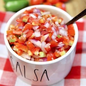 Salsa Fresca in a bowl with a spoon.