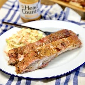 Sweet mustard spare ribs on a plate with coleslaw.