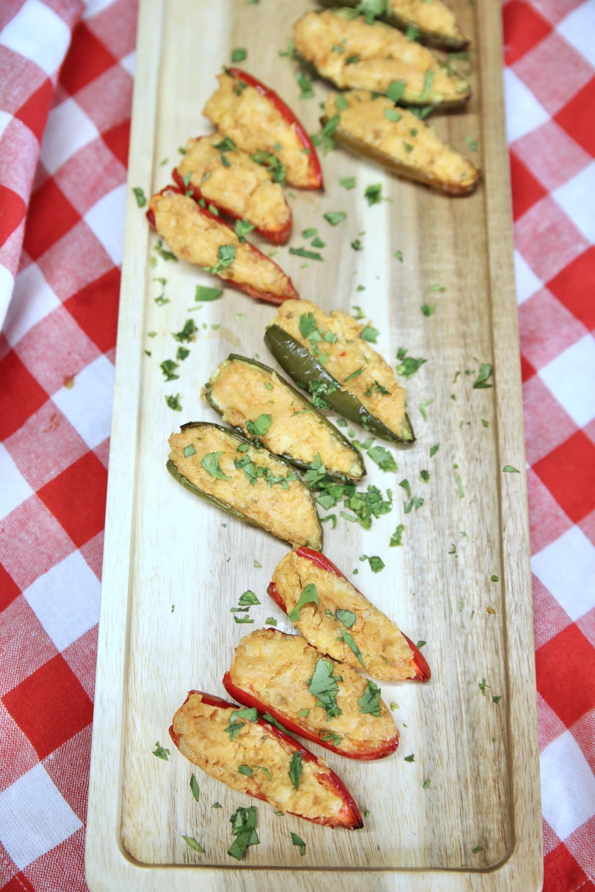 Jalapeno poppers on a wood board.