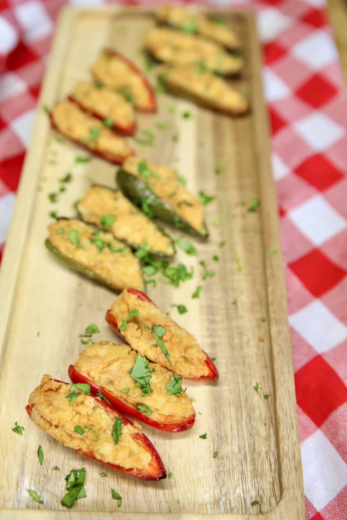 Grilled jalapeno poppers on an appetizer board.