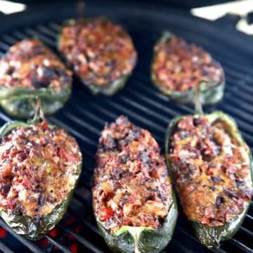 Brisket stuffed Poblano peppers on a grill.