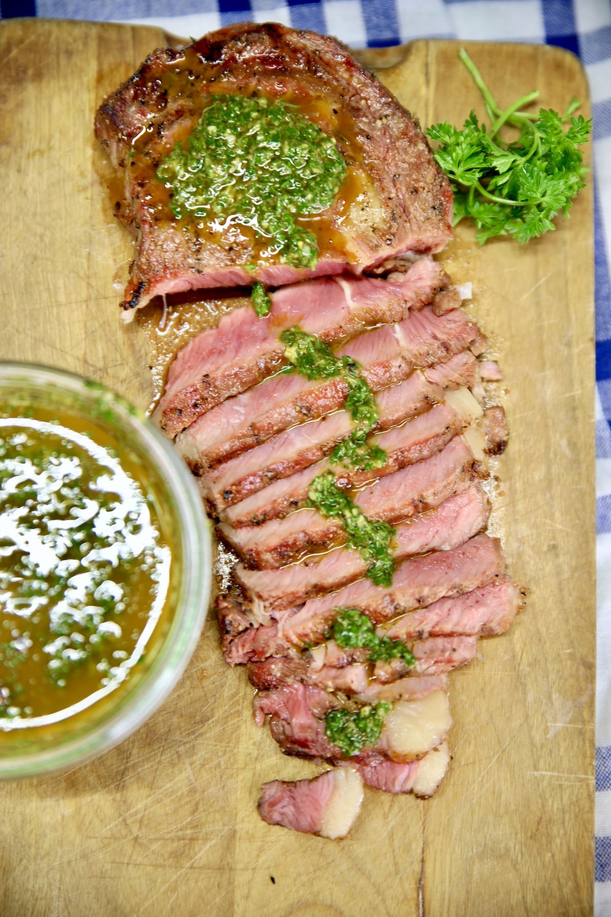 Chimichurri Steak on a cutting board, partially sliced.