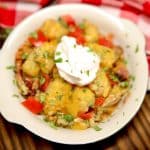Bowl of tater tot casserole with sour cream.