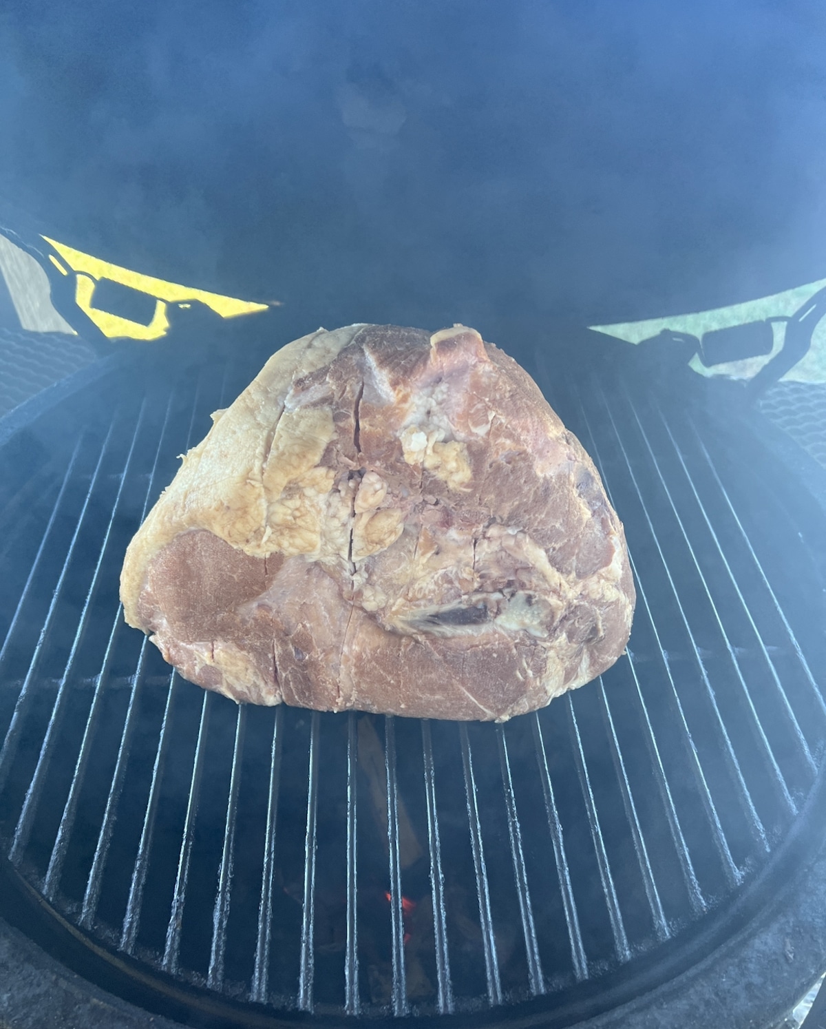 Grilling a half ham on a Big Green Egg ceramic grill.