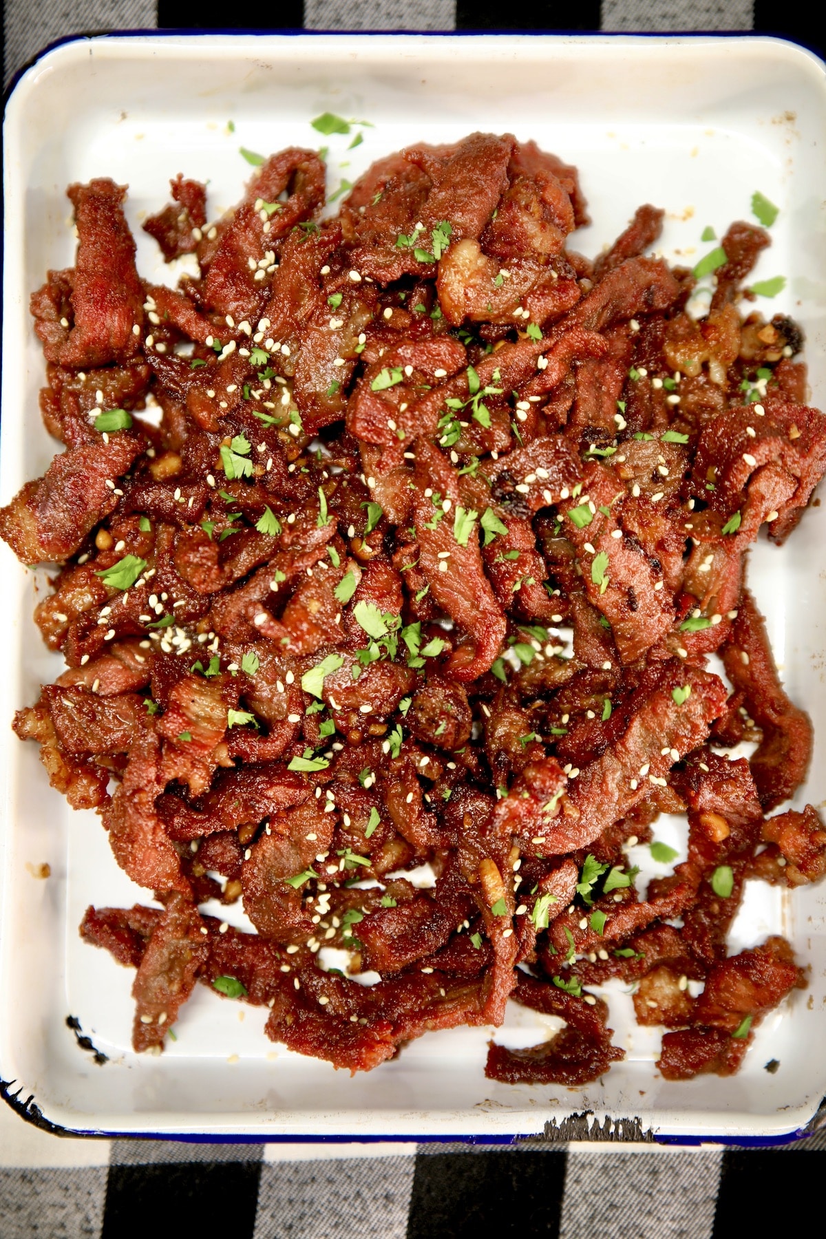 Thin sliced Asian steak with cilantro and sesame seeds.