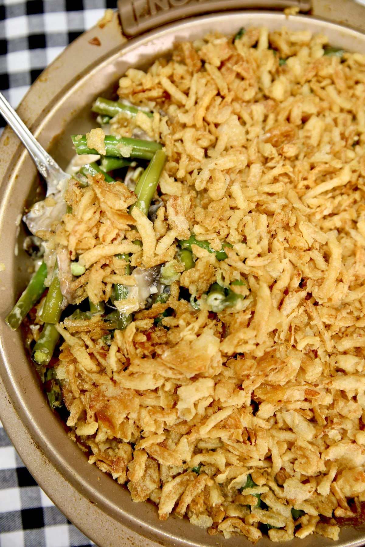 Pan of green bean casserole with serving spoon in the dish.