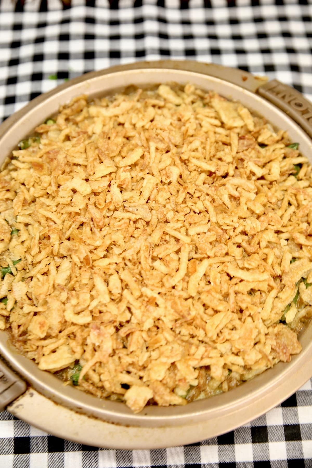 Pan of green bean casserole with french fried onions on top.