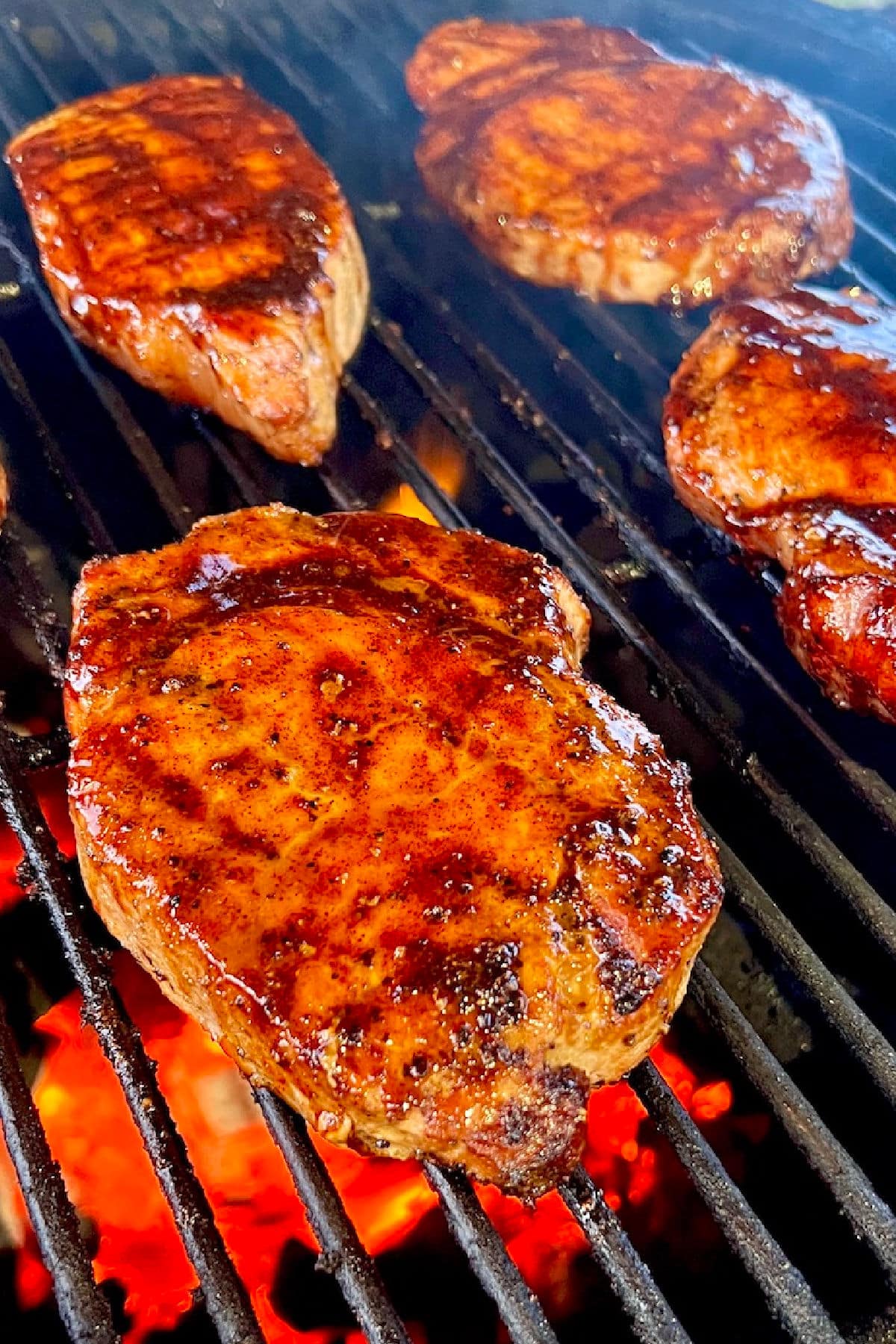 Pork chops on a grill.