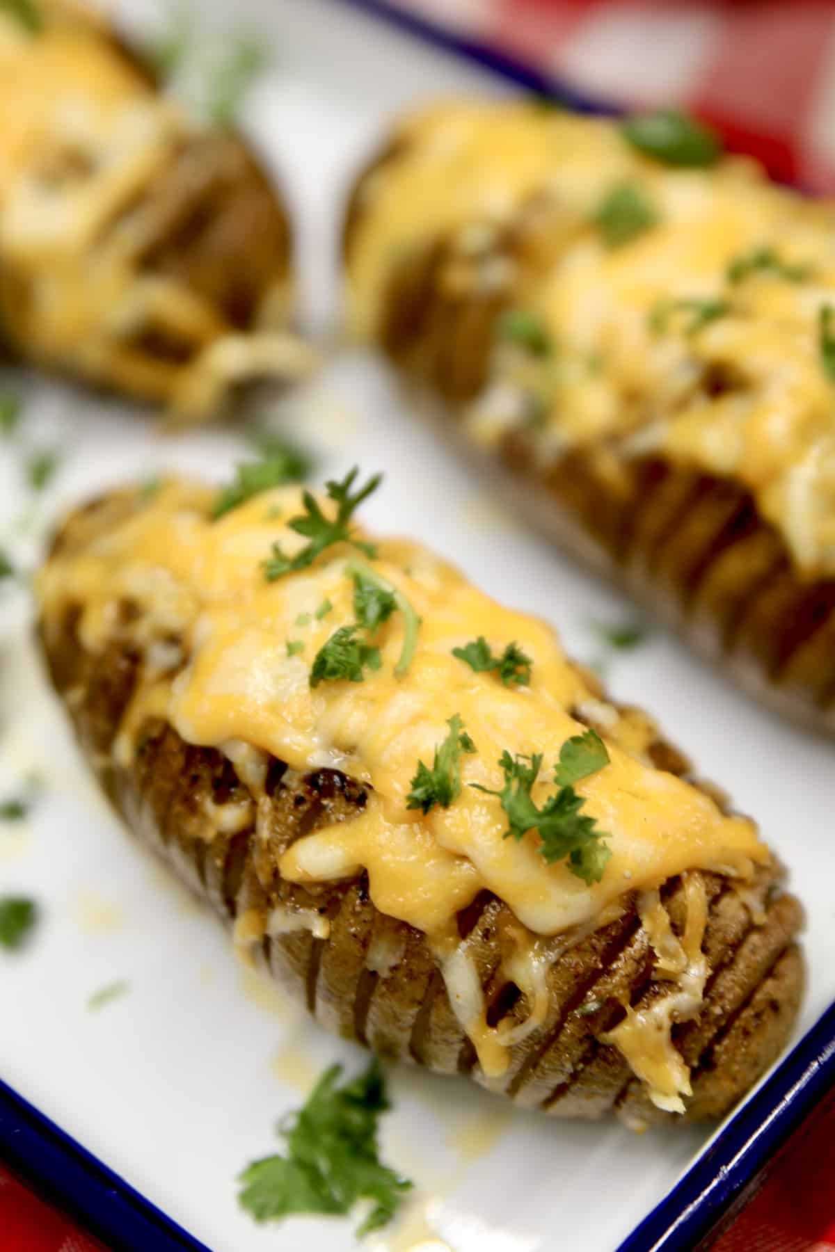 Cheese topped hasselback potatoes.