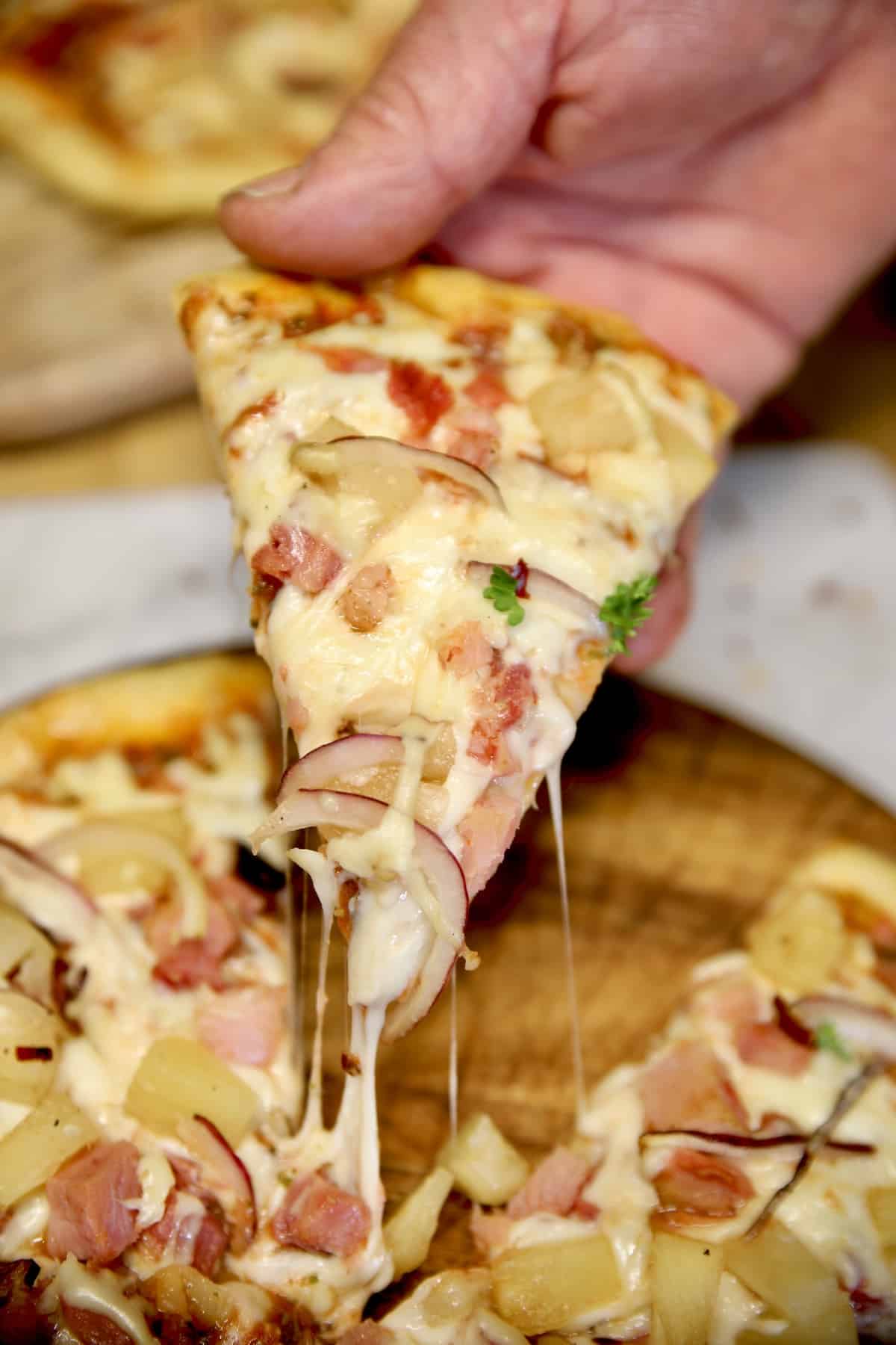 Slice of Hawaiian pizza.