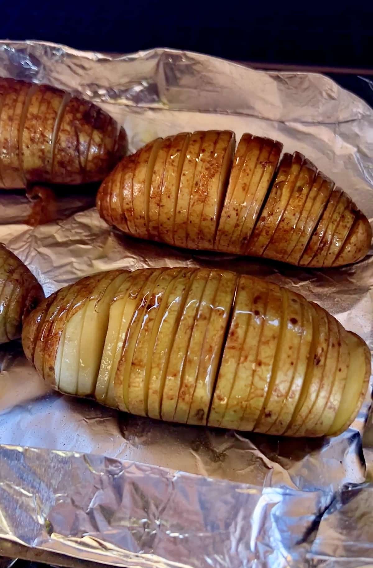 Hasselback potatoes cooking on a pellet grill.