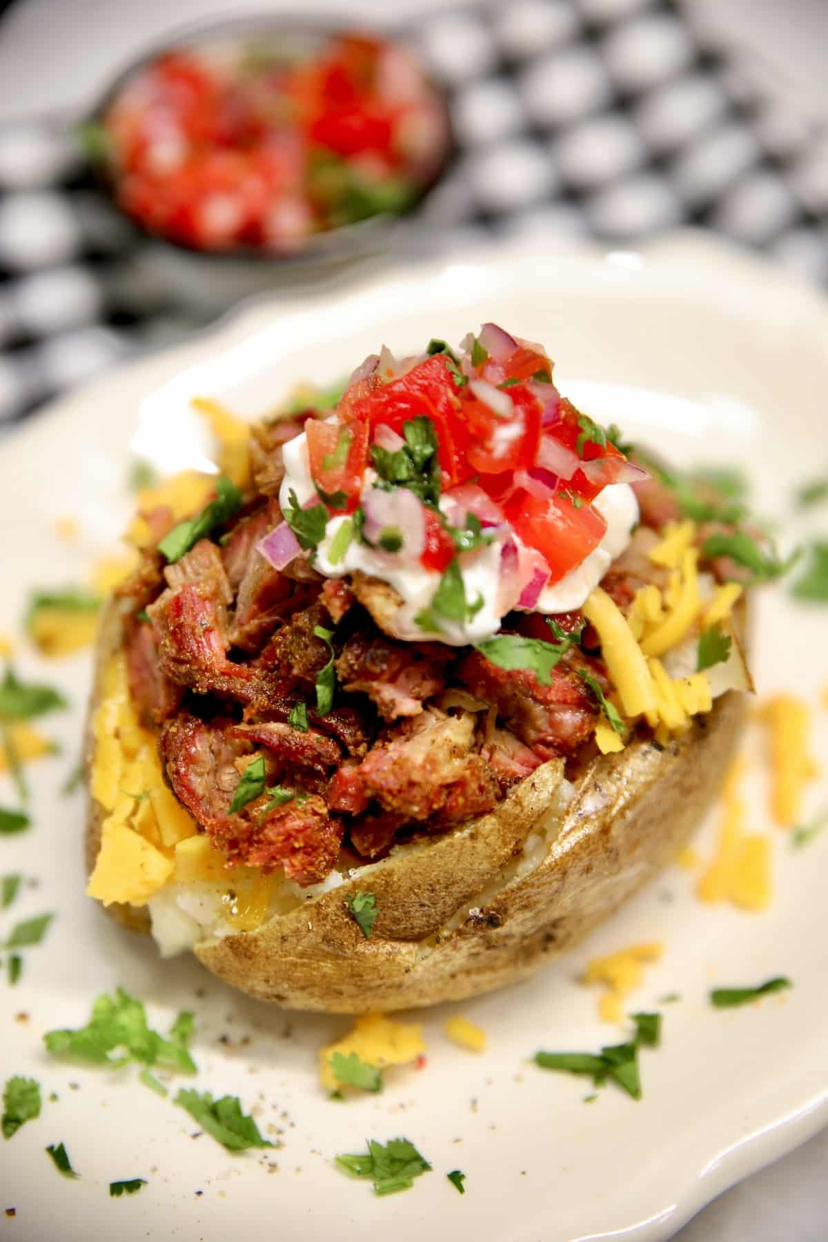 Loaded baked potato with shredded beef, cheese and salsa.