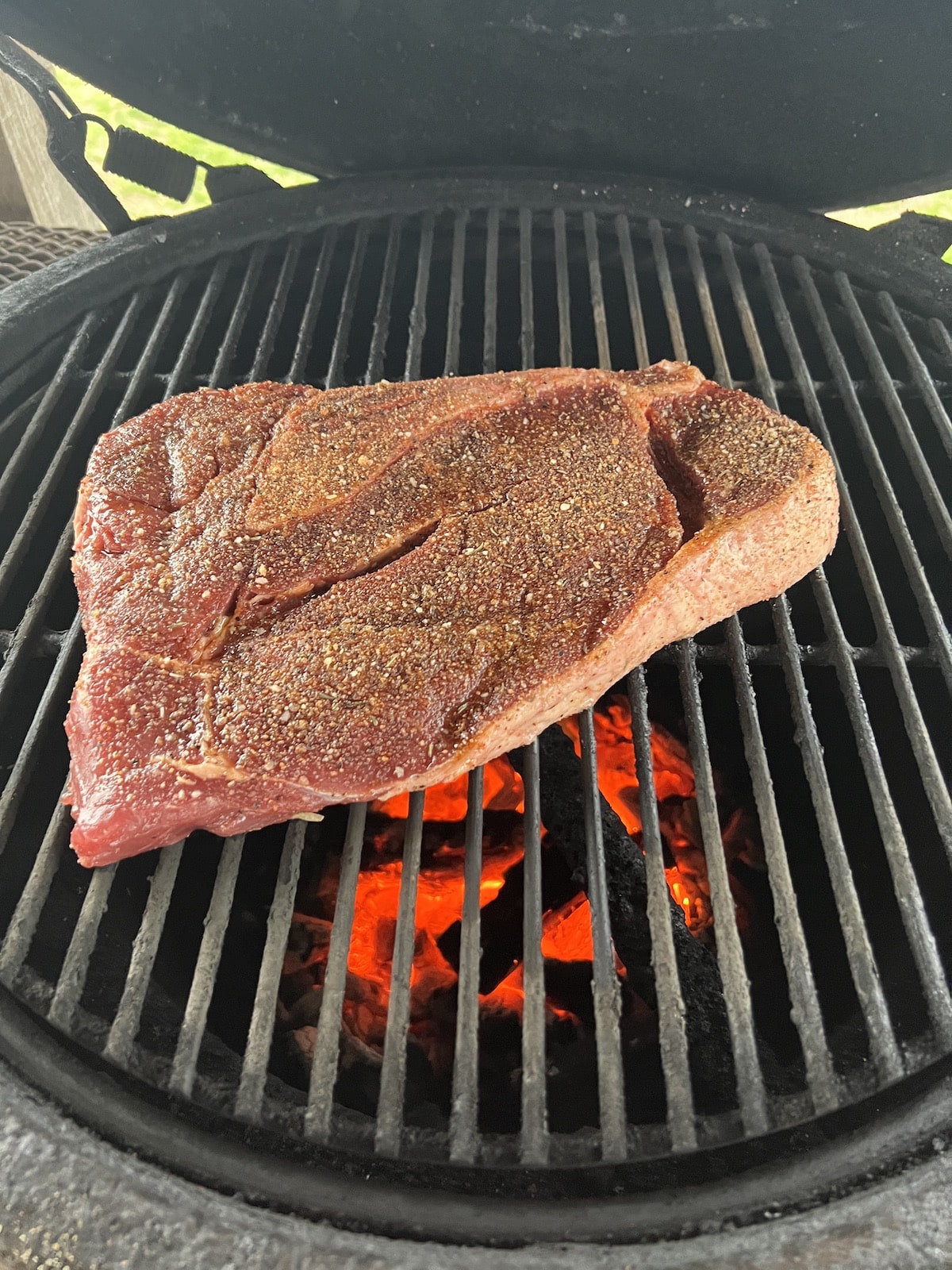 Sirloin steak on a charcoal grill.