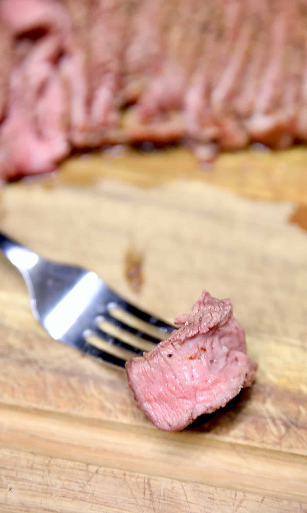 Sirloin steak bite on a fork.