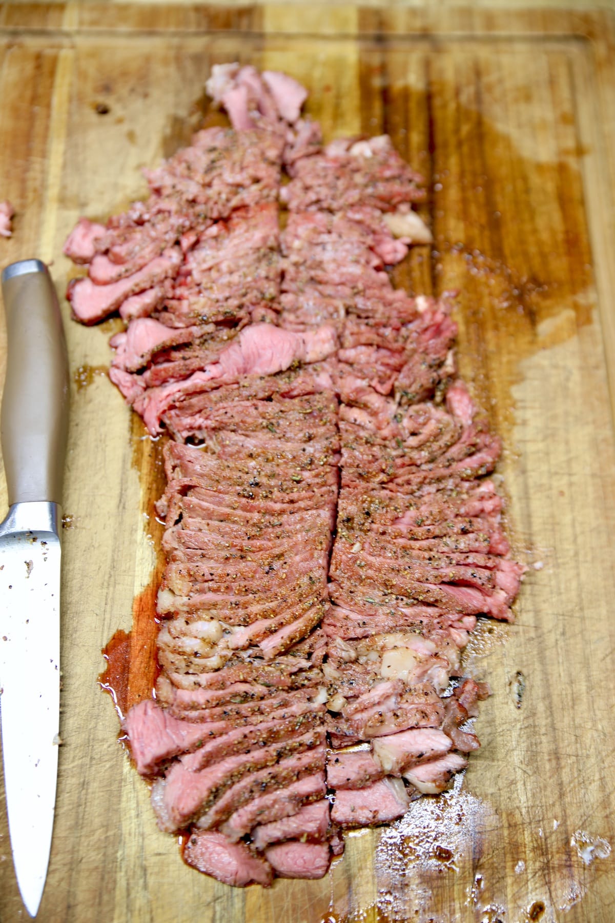 Sirloin steak, sliced on a cutting board.