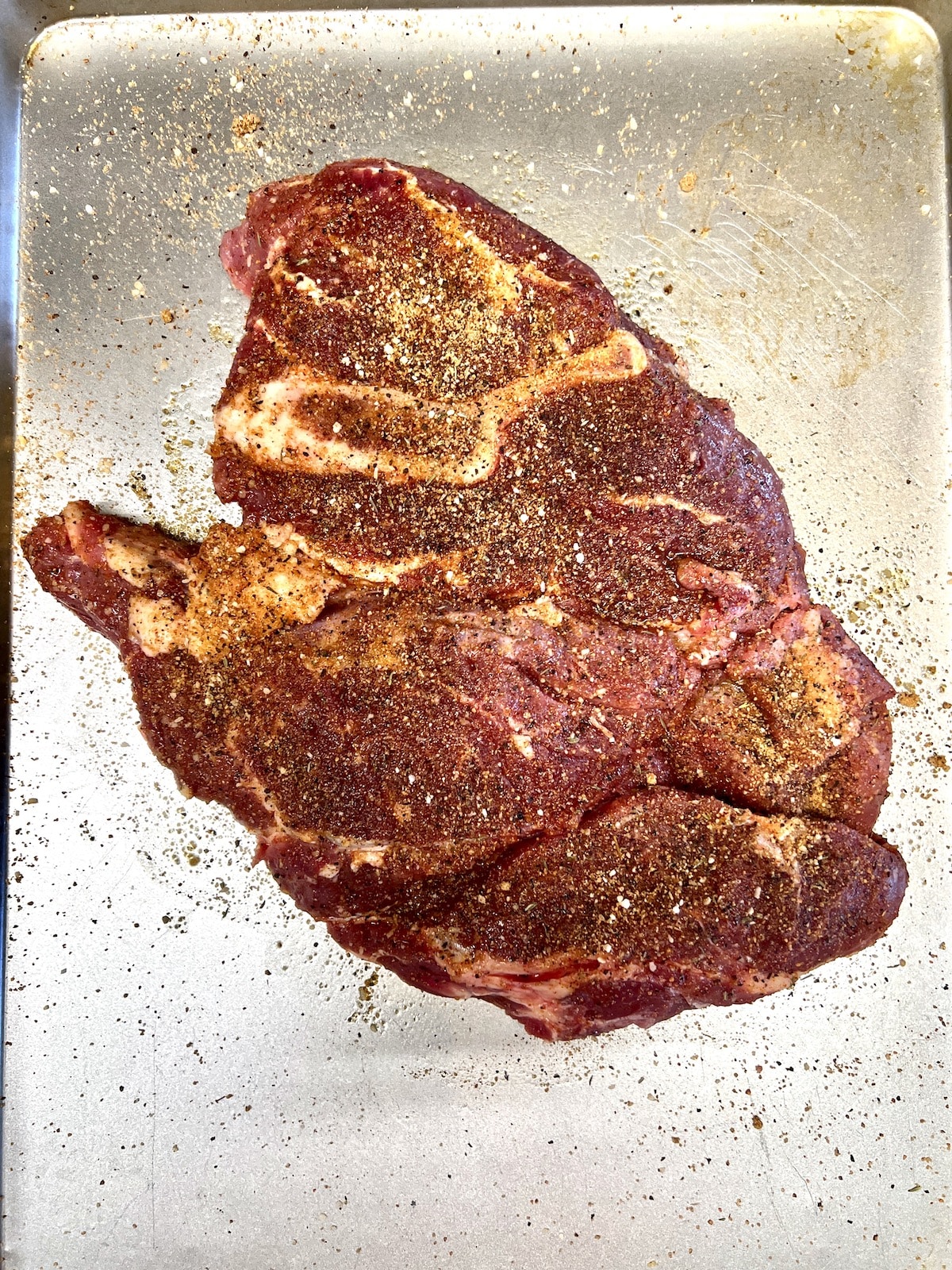 Sirloin steak seasoned with dry rub to grill. 