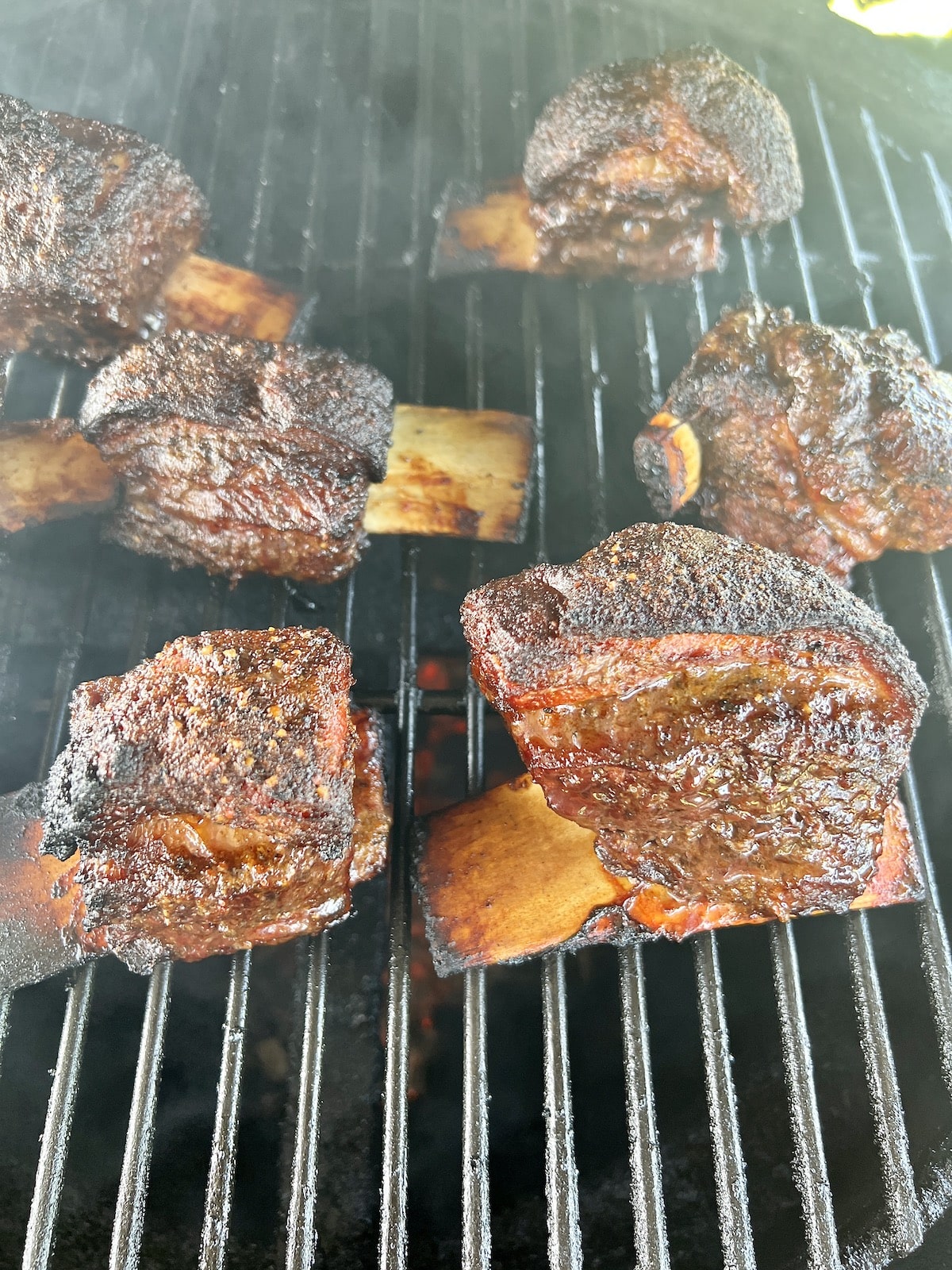 Short ribs on a grill.