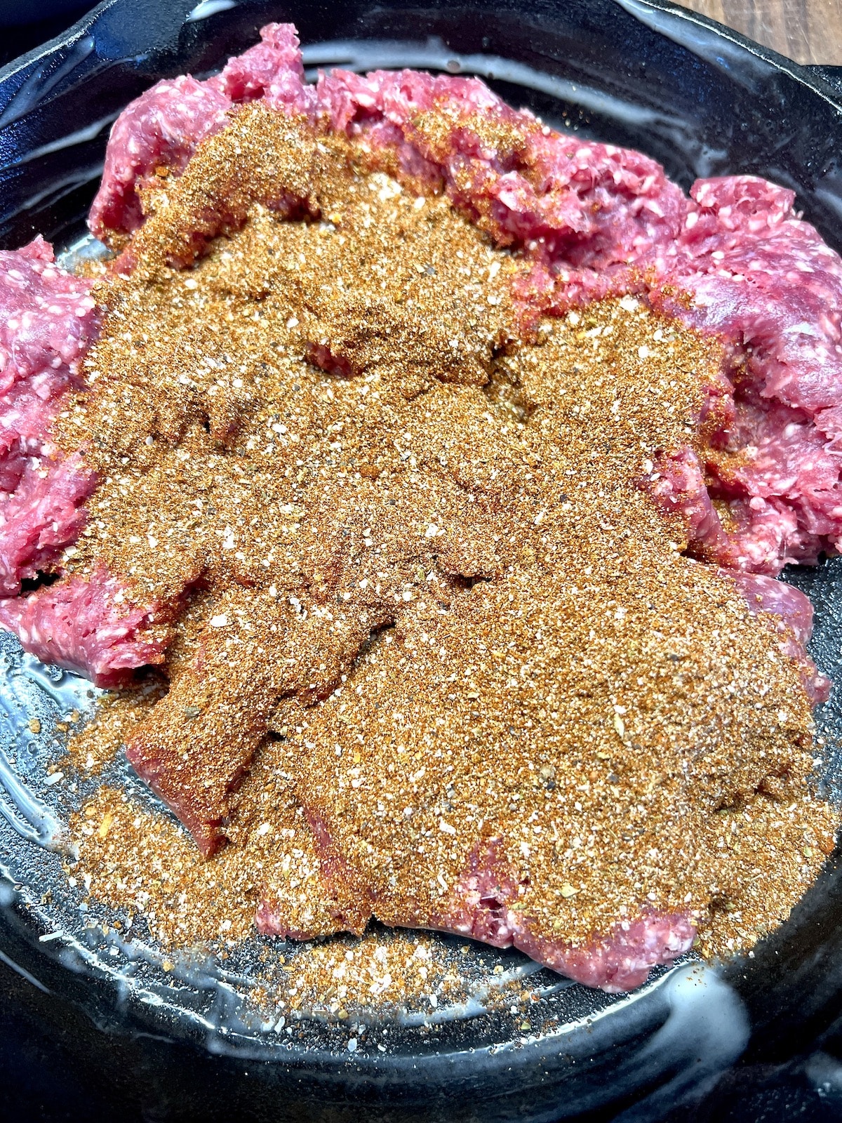 Ground beef with taco seasoning in skillet.