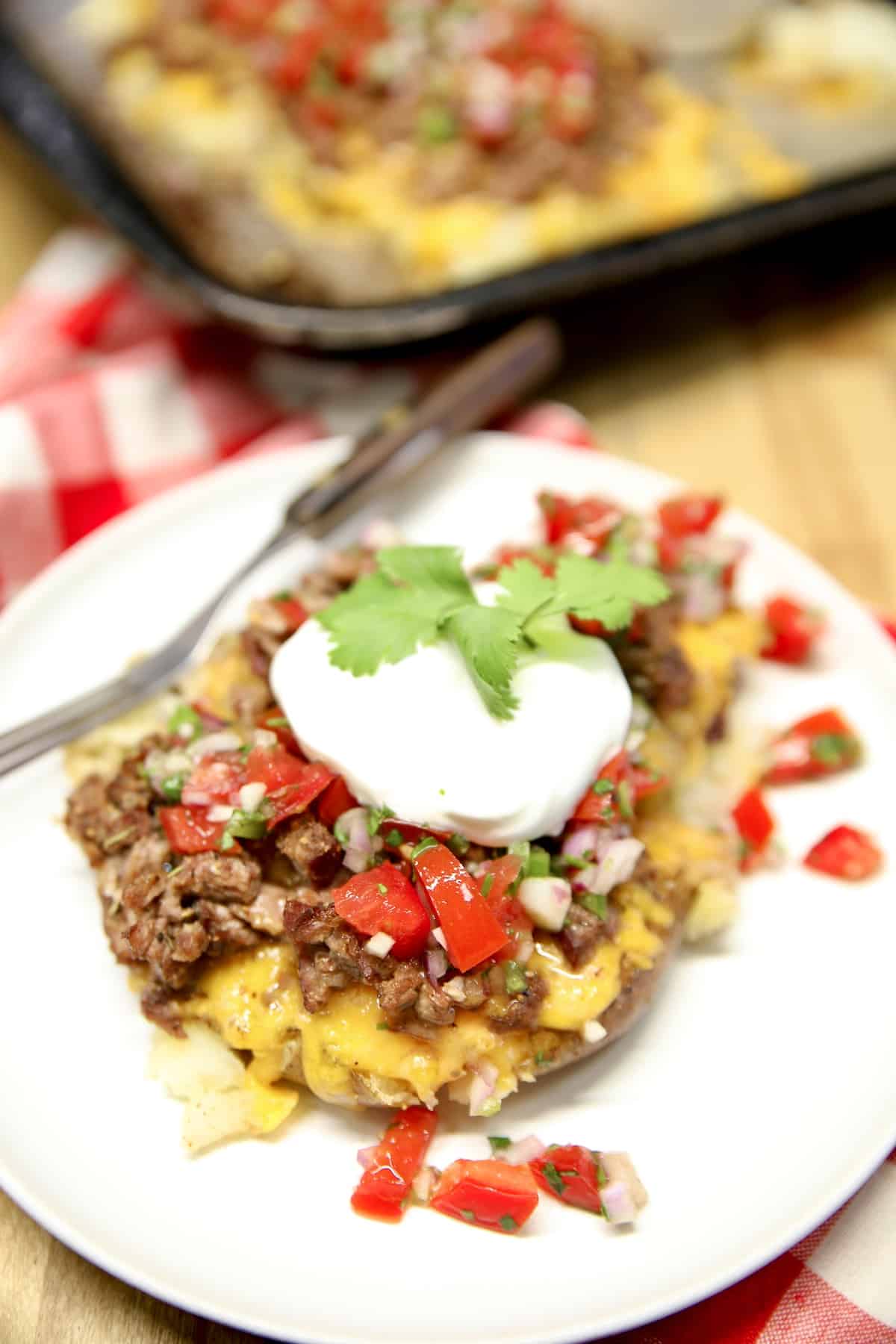 Loaded smashed potatoes with salsa fresca and sour cream.