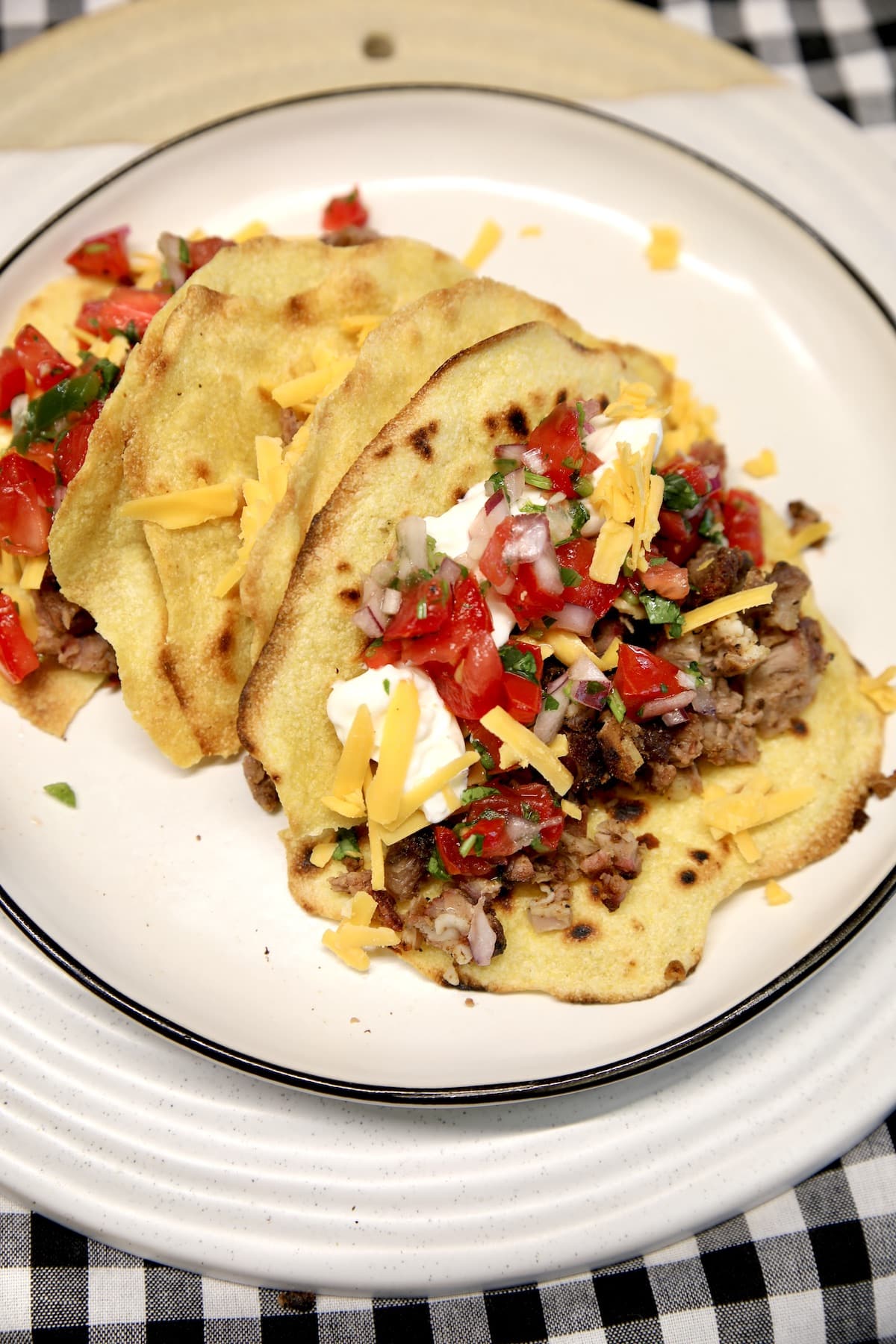 Short rib tacos with cheese and salsa.