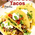 Smoked ground beef tacos on a plate - text overlay.