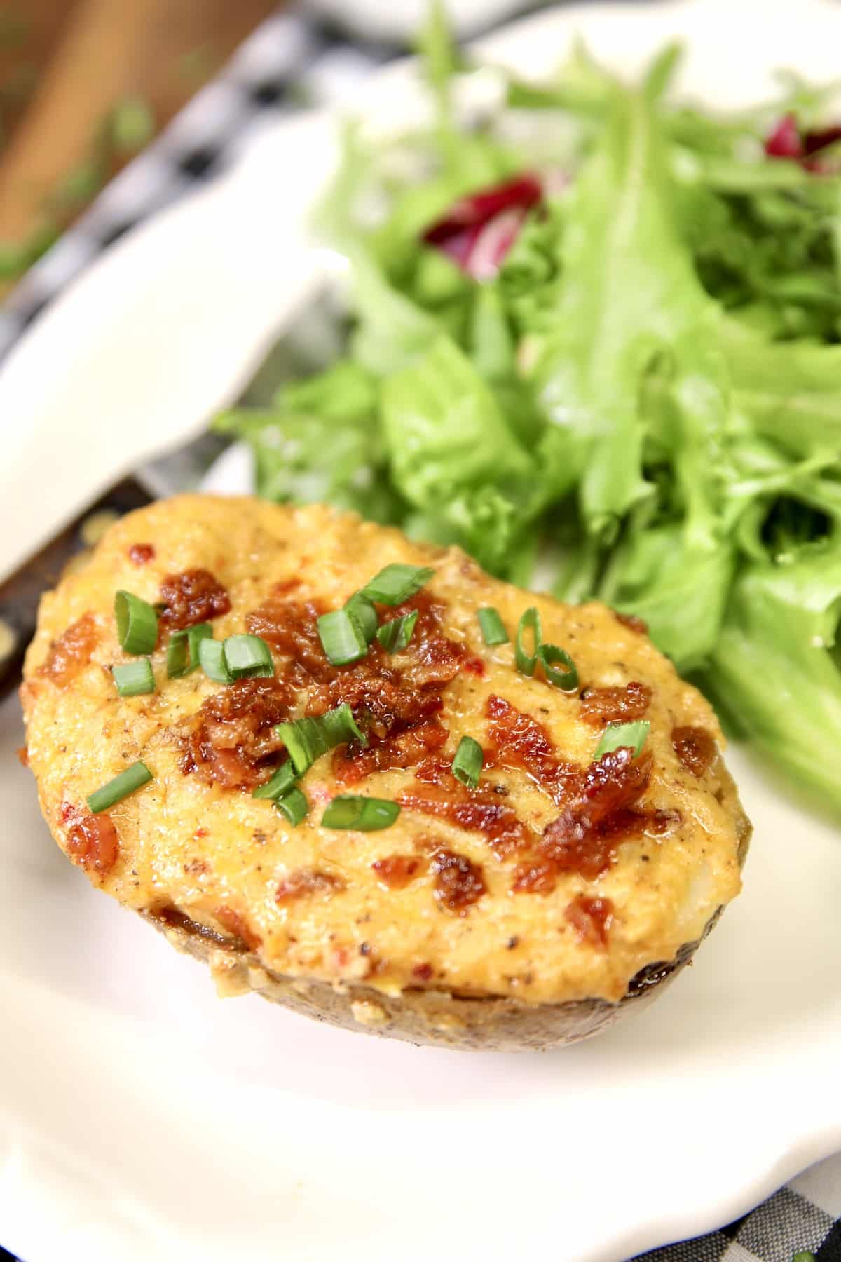 Pimento Cheese baked potato on a plate with salad.