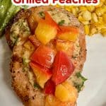 Grilled pork chops with peaches on a plate - text overlay.