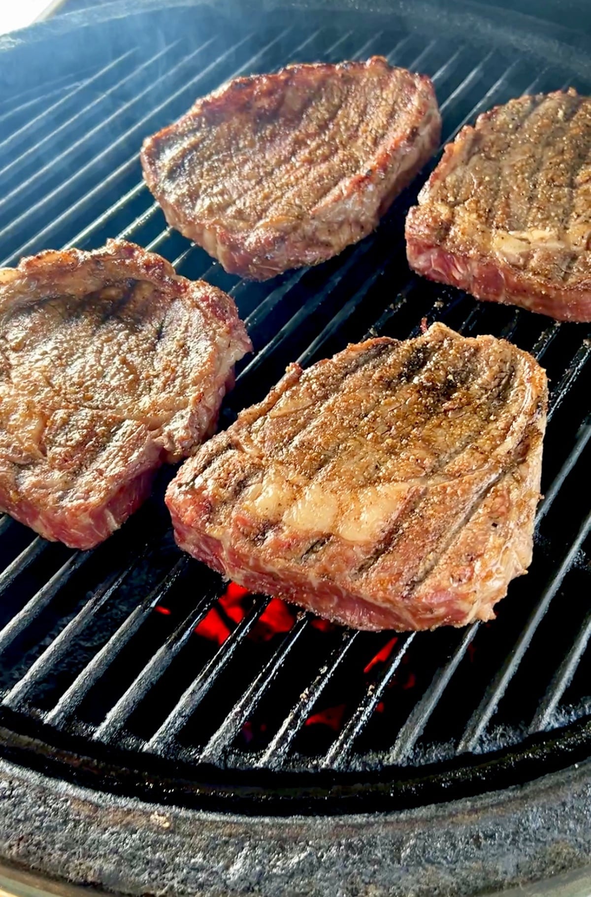 Grilling ribeye steaks.