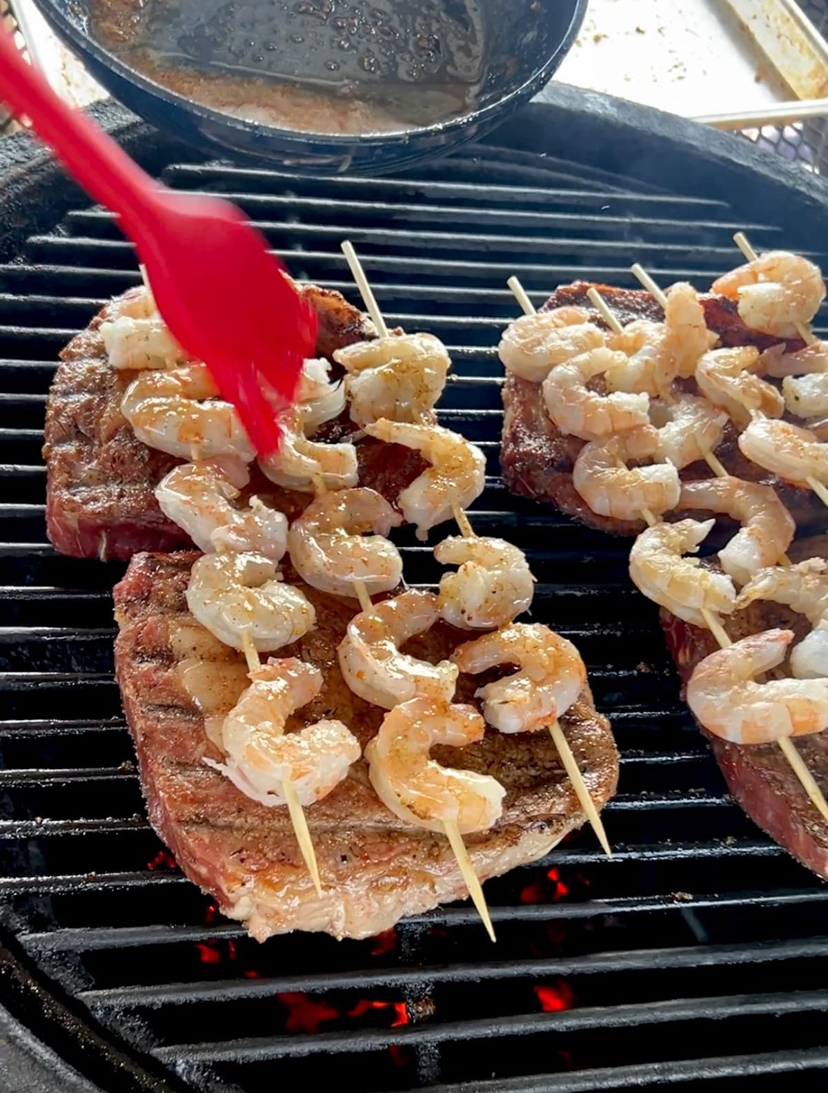 Grilling ribeyes with garlic butter shrimp.